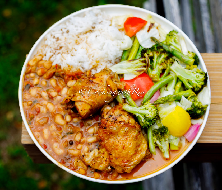 Caribbean Stewed Cannellini Beans served in a plate with roasted chicken and oven roasted veggies